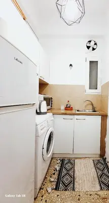 a kitchen with a white refrigerator and a sink at Apollonas in Athens