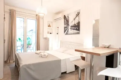 a white room with two beds and a table at Galini in Athens