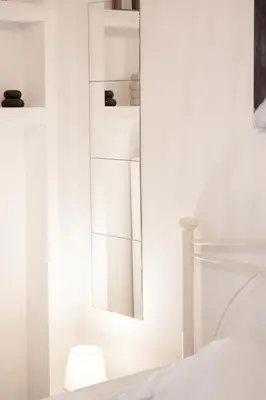 a bedroom with a mirror and a bed at Galini in Athens