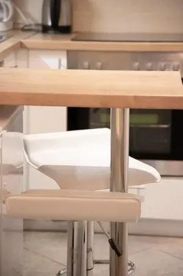 a wooden table with a white chair in a kitchen at Galini in Athens