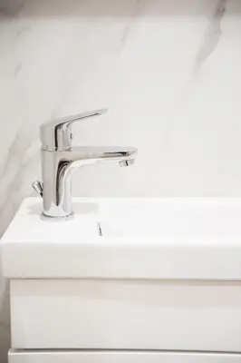 a bathroom sink with a chrome bathroom faucet at Galini in Athens