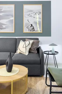 a living room with a couch and a table at Zen Vouliagmeni Beach Apartment in Athens