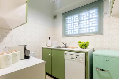 a kitchen with a green refrigerator and a sink at Zen Vouliagmeni Beach Apartment in Athens
