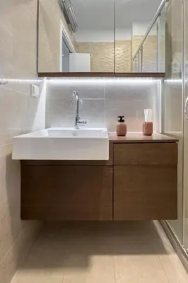 a bathroom with a sink and a mirror at Zen Vouliagmeni Beach Apartment in Athens