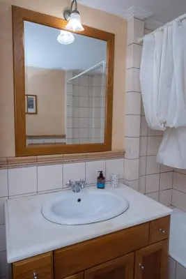 a bathroom with a sink and a mirror at Garden-studio in a mansion-Athens-Chalandri center in Athens