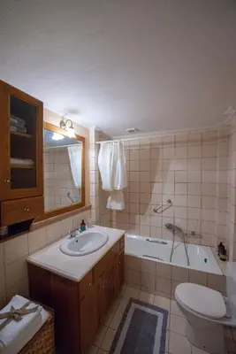 a bathroom with a sink and a toilet and a tub at Garden-studio in a mansion-Athens-Chalandri center in Athens