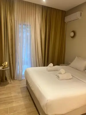 a bedroom with a bed with towels on it at Athens Ilisiam in Athens