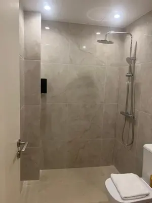 a shower with a glass door in a bathroom at Athens Ilisiam in Athens