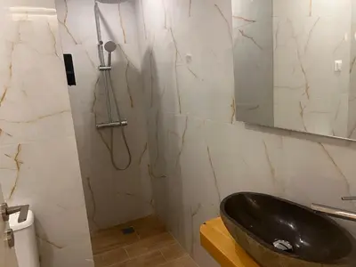 a bathroom with a black sink and a mirror at Athens Ilisiam in Athens