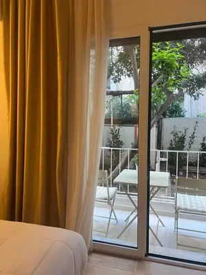 a bedroom with a bed and a sliding glass door at Athens Ilisiam in Athens