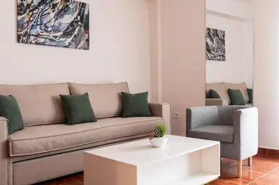 a living room with a couch and a chair at Erechthiou 15 Koukaki Apartment by Athens Concept Residences in Athens