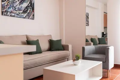 a living room with a couch and a chair at Erechthiou 15 Koukaki Apartment by Athens Concept Residences in Athens