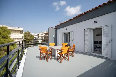 a patio with a table and chairs on a balcony at Oikia in Athens