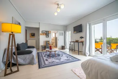 a living room with a bed and a couch at Oikia in Athens