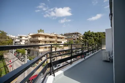 a balcony with a view of a street and buildings at Oikia in Athens