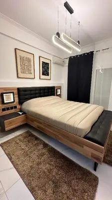 a bedroom with a large bed with a black couch at LIttLE PARADISE in Athens