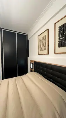 a bedroom with a large bed and a black couch at LIttLE PARADISE in Athens