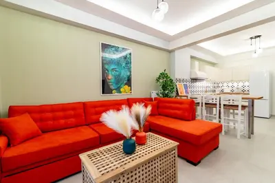 a living room with a red couch and a table at Psirri Urban Chic in Athens