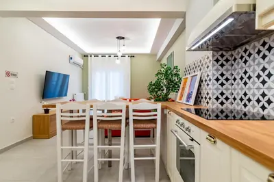 a kitchen with a table and stools in a room at Psirri Urban Chic in Athens