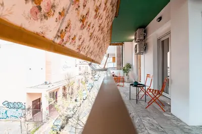 a room with a balcony with a view of a building at Psirri Urban Chic in Athens