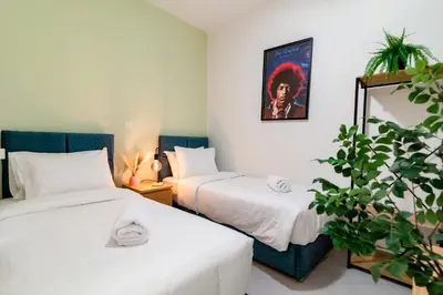 a room with two beds and a plant at Psirri Urban Chic in Athens