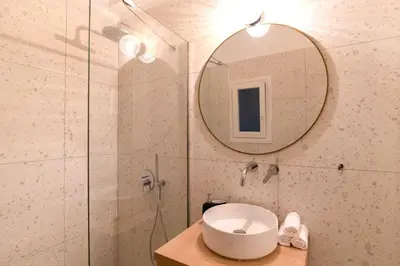 a bathroom with a sink and a mirror at Psirri Urban Chic in Athens