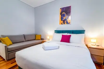 a bedroom with a large bed and a couch at Psirri Urban Chic in Athens