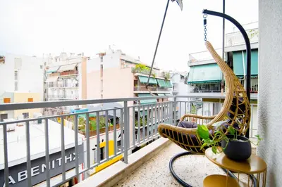a hammock on a balcony overlooking a city at The Parthenon Porch for Familys & Groups , 4BR ! in Athens