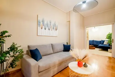 a living room with a couch and a table at The Parthenon Porch for Familys & Groups , 4BR ! in Athens