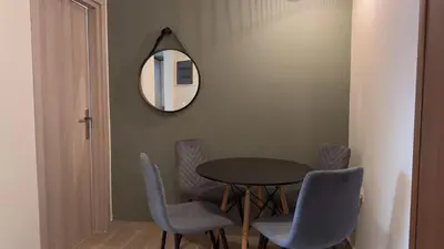 a dining room with a table and chairs and a mirror at Nicolas Home in Athens