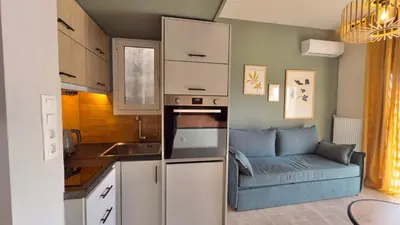 a small kitchen with a couch in a room at Nicolas Home in Athens