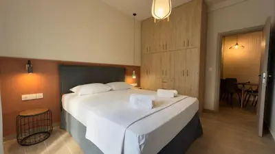 a bedroom with a large bed with two towels on it at Nicolas Home in Athens
