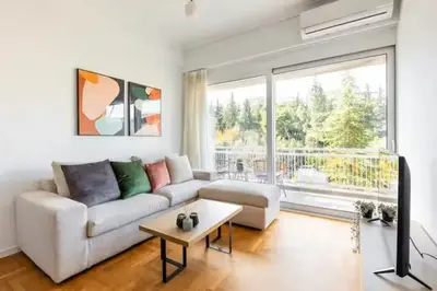 a living room with a white couch and a table at 2br Apt Near Ancient Stadium MK in Athens
