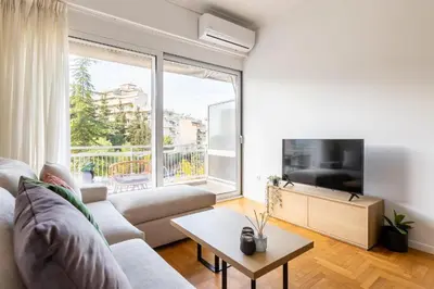 a living room with a couch and a large window at 2br Apt Near Ancient Stadium MK in Athens