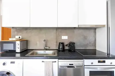 a kitchen with a sink and a microwave at 2br Apt Near Ancient Stadium MK in Athens