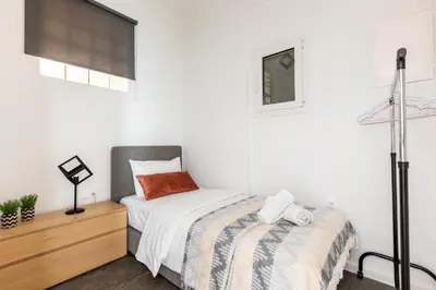 a bedroom with a bed and a wooden dresser at 2br Apt Near Ancient Stadium MK in Athens