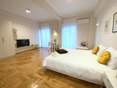 a bedroom with a large white bed with yellow pillows at MediTerra Stay Athens City Center in Athens