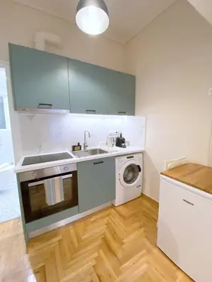 a kitchen with a sink and a washing machine at MediTerra Stay Athens City Center in Athens