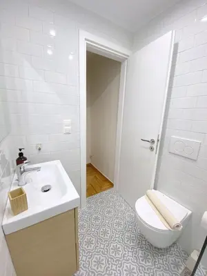 a white bathroom with a toilet and a sink at MediTerra Stay Athens City Center in Athens