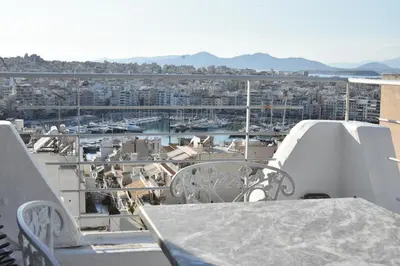 a balcony with a view of a harbor at Modern Apartment with Stunning Piraeus Views in Piraeus