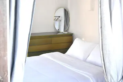 a bedroom with a bed and a mirror at Modern Apartment with Stunning Piraeus Views in Piraeus