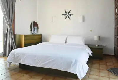 a bedroom with a large white bed and a window at Modern Apartment with Stunning Piraeus Views in Piraeus