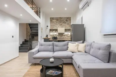 a living room with a couch and a table at PetraLab By Greece Apartments in Athens