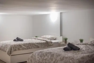 a bedroom with two beds and a table at PetraLab By Greece Apartments in Athens