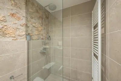 a bathroom with a shower with a glass door at PetraLab By Greece Apartments in Athens