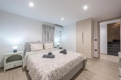 a bedroom with a bed with two towels on it at PetraLab By Greece Apartments in Athens