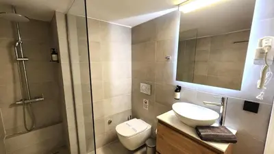 a bathroom with a shower and a toilet and a sink at Grec Maison Piraeus by GrecCollection in Piraeus
