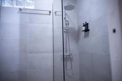 a shower with a glass door in a bathroom at Grec Maison Piraeus by GrecCollection in Piraeus
