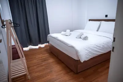 a bedroom with a bed with white sheets and a ladder at Grec Maison Piraeus by GrecCollection in Piraeus