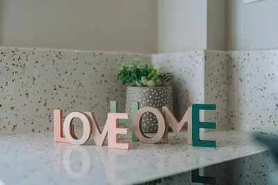 a love sign on a counter with a potted plant at Brand New Building Deluxe Apartments With Parking Nearby Train in Athens